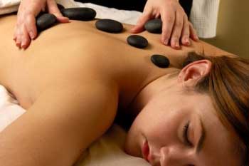 women getting hot stone massage